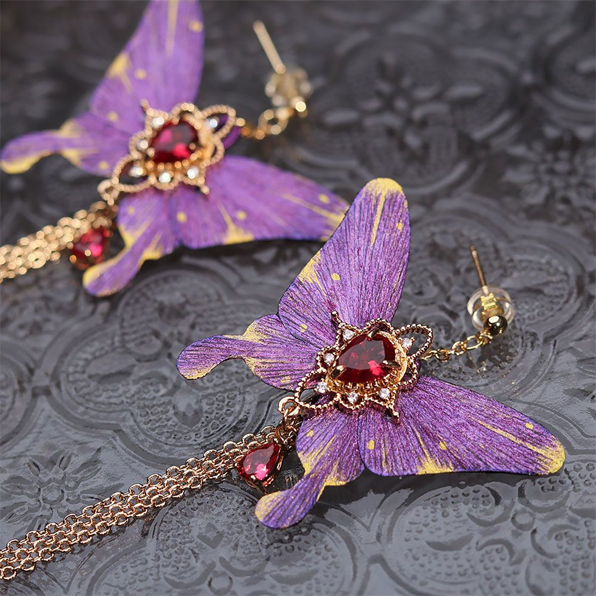 Purple butterfly tassel earrings presented in CLMADE gift packaging
