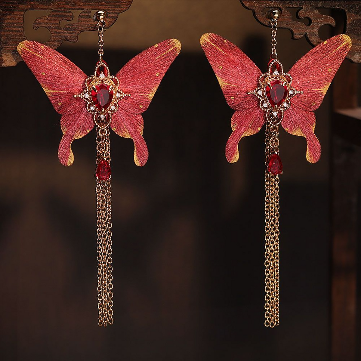 Red butterfly silk tassel earrings showing the full pendant and chain length