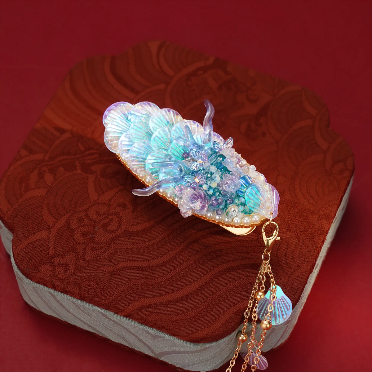 Ao Bing Dragon Hair Clip displayed on a red fabric box