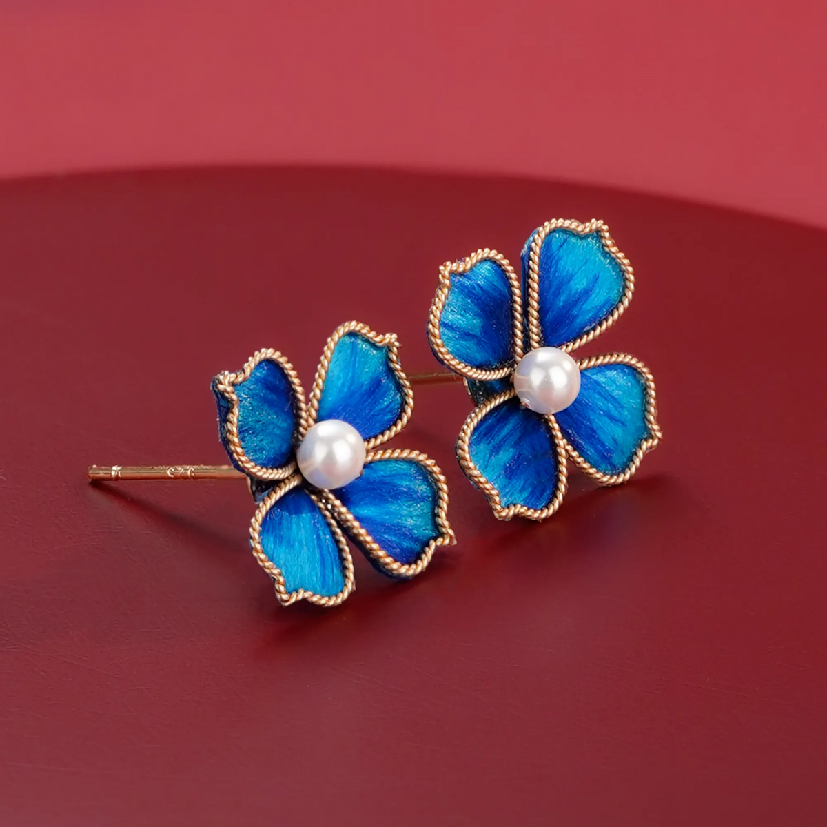 Angled close-up of Blue Four-Leaf Clover Ronghua Stud Earrings