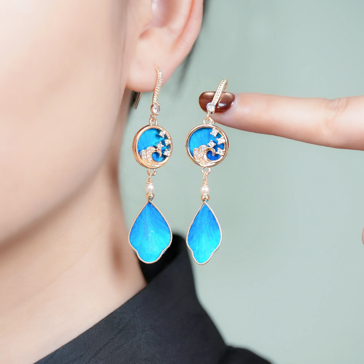 Handmade blue Canglan wave Ronghua drop earrings worn close up