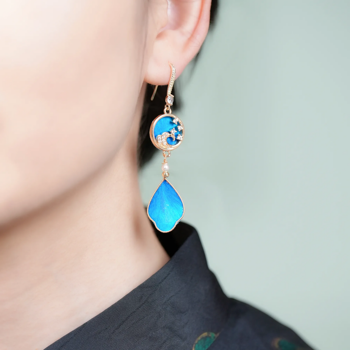 Single blue Canglan wave Ronghua drop earring shown on the ear