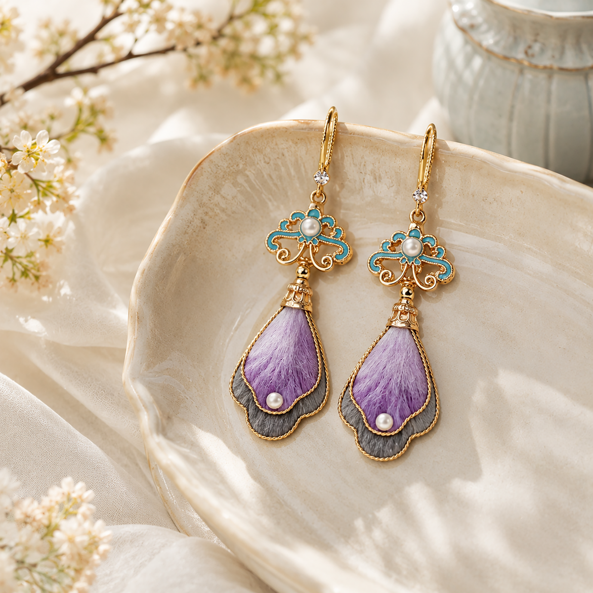 Pair of lavender mulberry silk velvet earrings displayed on ivory silk