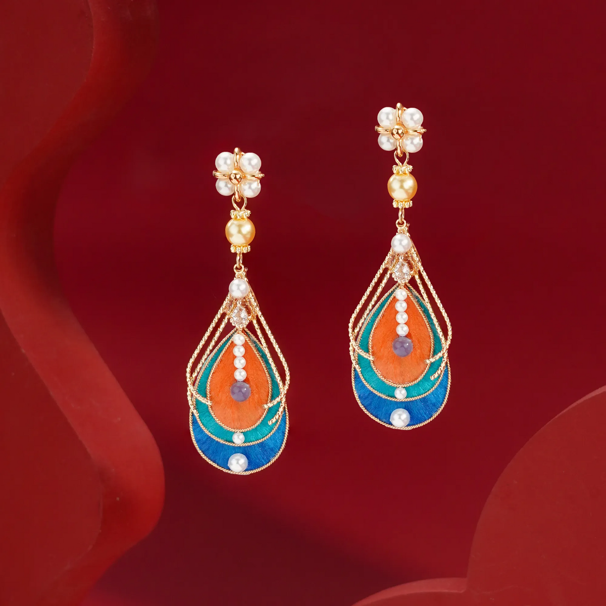 Long orange turquoise and blue Ronghua earrings with gold-tone details