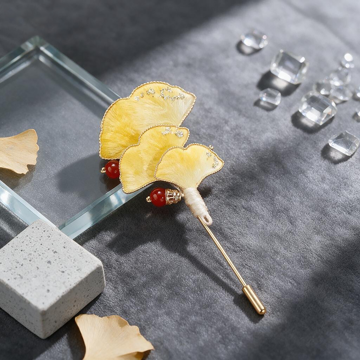 Ginkgo Ronghua wirework stickpin brooch on a dark grey surface