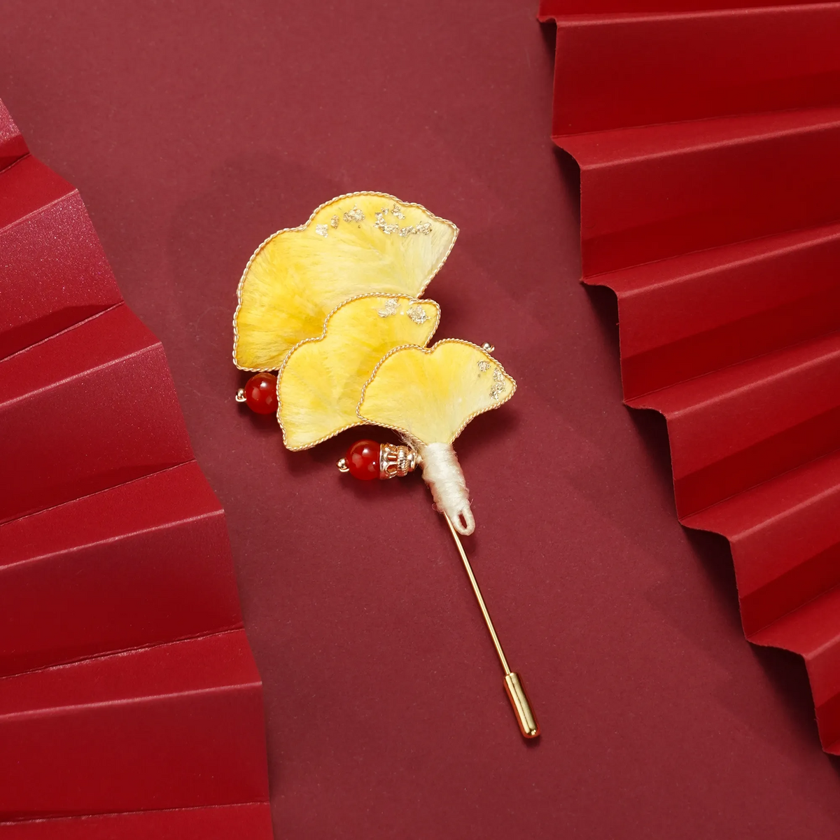 Ginkgo Ronghua wirework stickpin brooch on a red background