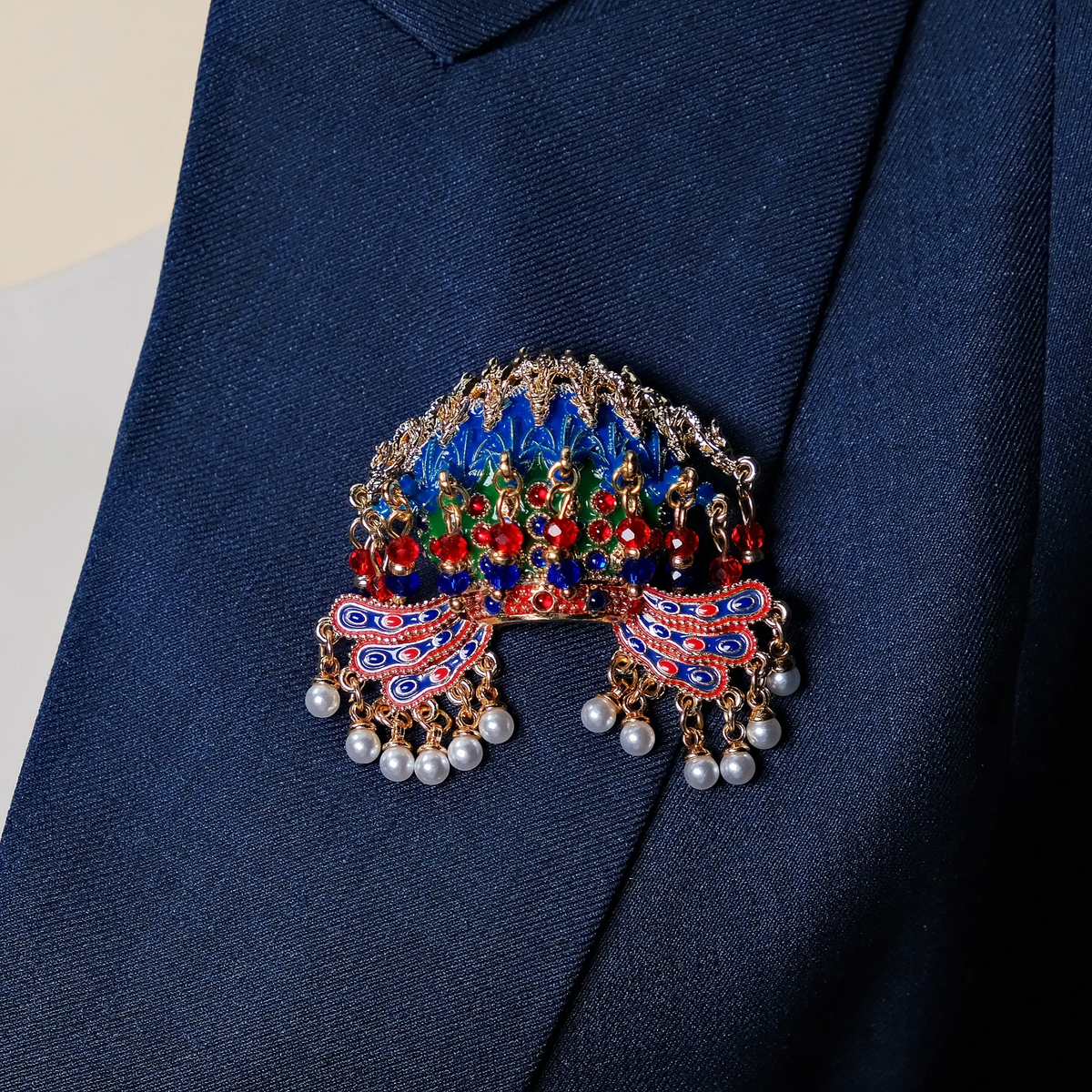 Nine Dragons and Nine Phoenixes Crown Sweater Brooch worn on a dark blue lapel