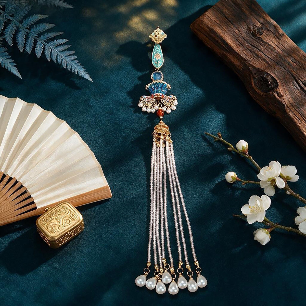 Nine Dragons and Nine Phoenixes Qipao Brooch with long tassel on a dark green surface