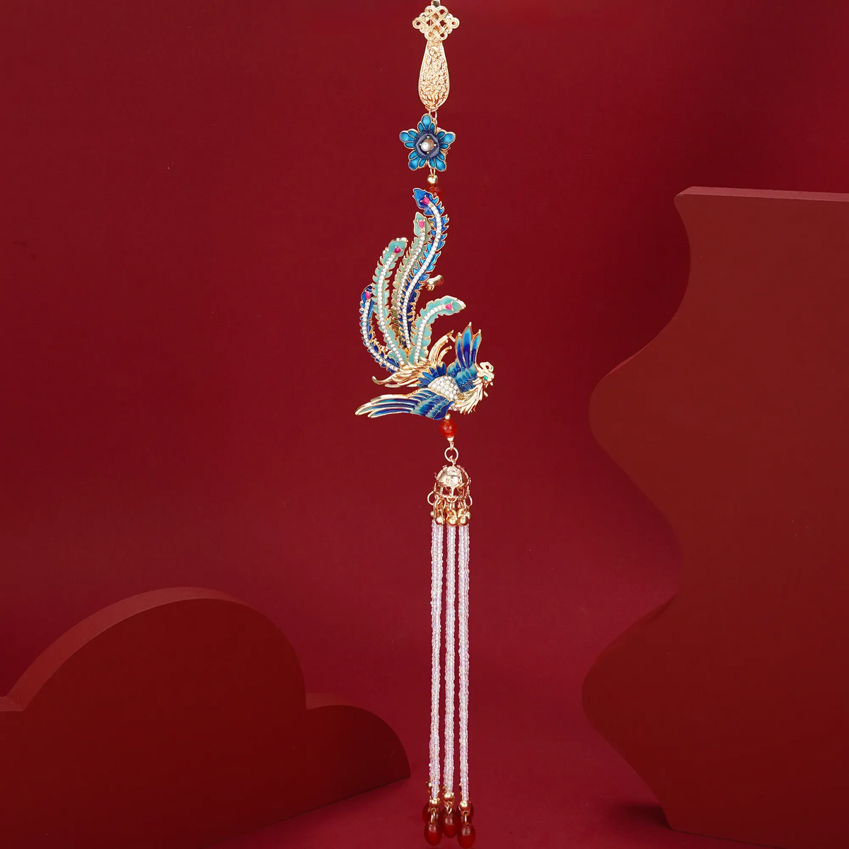 Phoenix Arrival Brooch long tassel detail on a red background