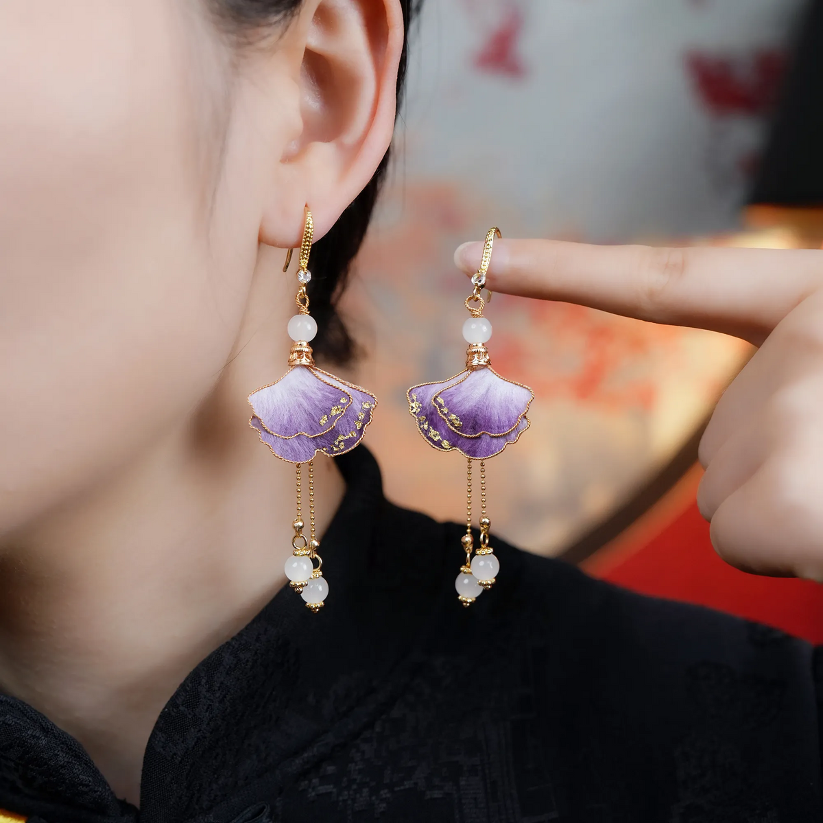 Model wearing and holding matching purple ginkgo Ronghua earrings