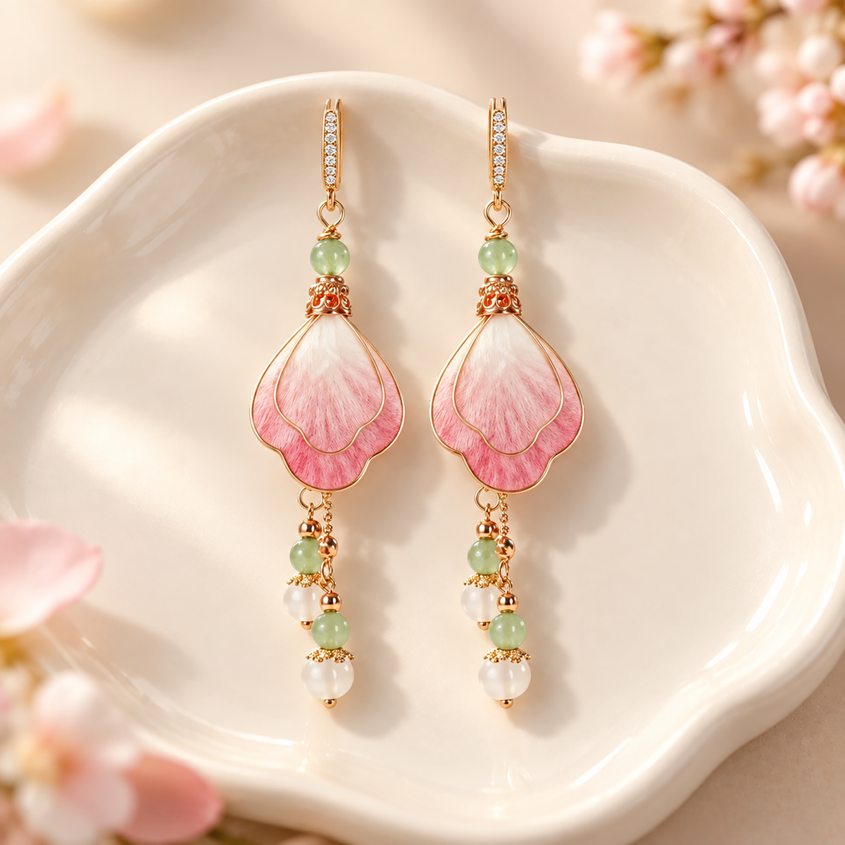 Layered pink and ivory silk petals with green and white bead drops on a white dish